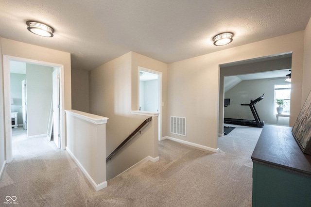 14514 Glapthorn Rd, Fishers, IN 46037 - corridor with an upstairs landing, light colored carpet, and a textured ceiling