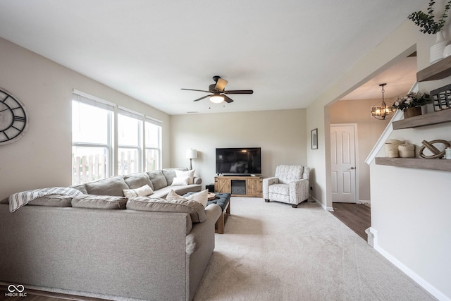 14514 Glapthorn Rd, Fishers, IN 46037 - carpeted living room with a ceiling fan and a chandelier