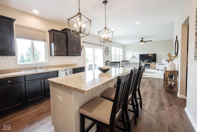 14514 Glapthorn Rd, Fishers, IN 46037 - kitchen featuring backsplash, a ceiling fan, open floor plan, a kitchen bar, and recessed lighting