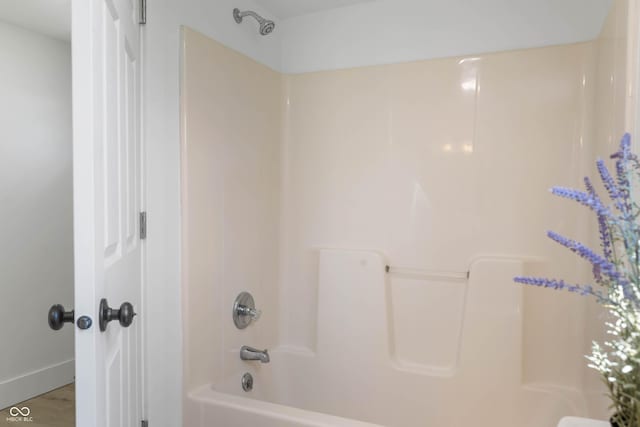 2602 State St, New Castle, IN 47362 - bathroom with shower / bathtub combination, baseboards, and wood finished floors