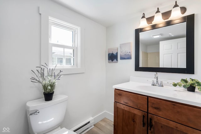 2602 State St, New Castle, IN 47362 - bathroom featuring a baseboard heating unit, wood finished floors, vanity, toilet, and baseboards