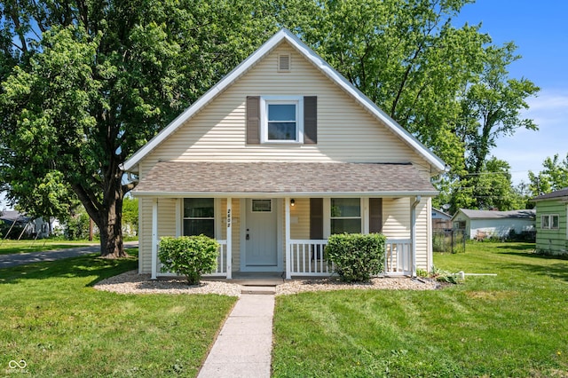 2602 State St, New Castle, IN 47362 - bungalow-style house with covered porch, a front lawn, and a shingled roof