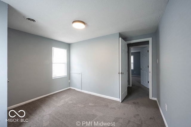 5050 W Regent St, Indianapolis, IN 46241 - unfurnished bedroom featuring carpet, baseboards, and a textured ceiling