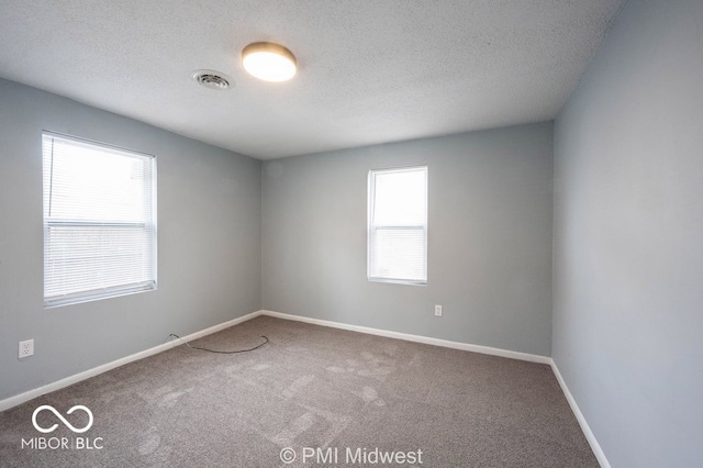 5050 W Regent St, Indianapolis, IN 46241 - carpeted spare room with a textured ceiling and baseboards