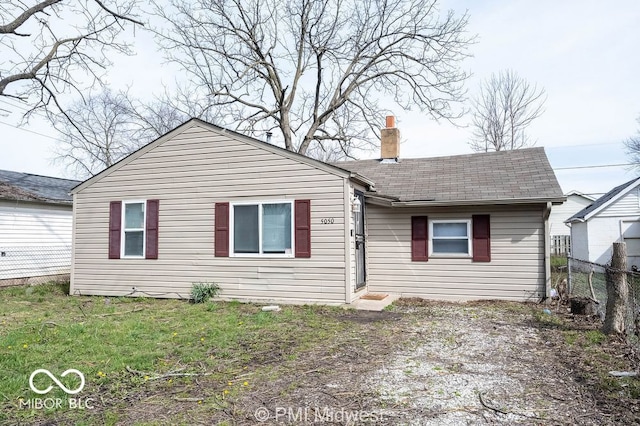 5050 W Regent St, Indianapolis, IN 46241 - view of front facade with a chimney and a shingled roof
