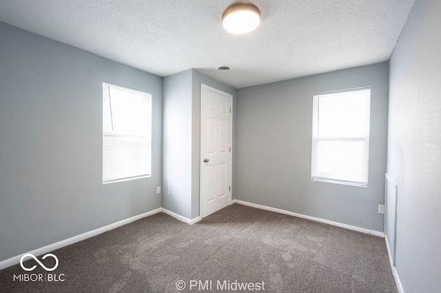 5050 W Regent St, Indianapolis, IN 46241 - unfurnished bedroom with carpet, a textured ceiling, and baseboards
