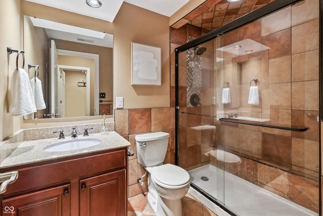 8663 N Commonview Dr, Mccordsville, IN 46055 - bathroom featuring toilet, vanity, a shower stall, tile walls, and wainscoting