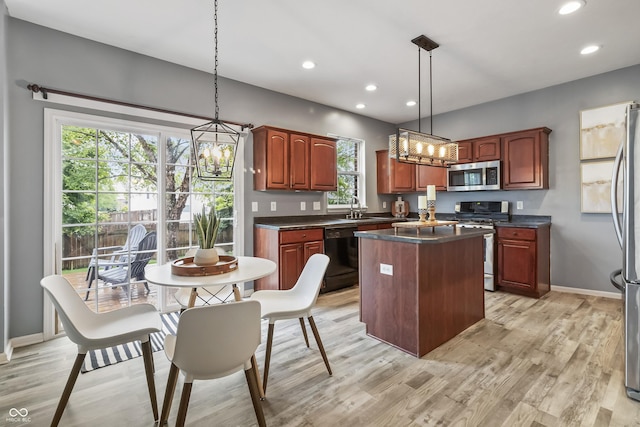 8663 N Commonview Dr, Mccordsville, IN 46055 - kitchen with stainless steel appliances, a chandelier, a sink, dark countertops, and a kitchen island