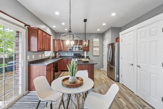 8663 N Commonview Dr, Mccordsville, IN 46055 - kitchen featuring stainless steel appliances, a sink, a chandelier, dark countertops, and a center island