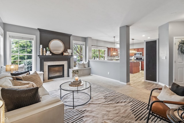 8663 N Commonview Dr, Mccordsville, IN 46055 - living area featuring plenty of natural light, baseboards, a tiled fireplace, and recessed lighting