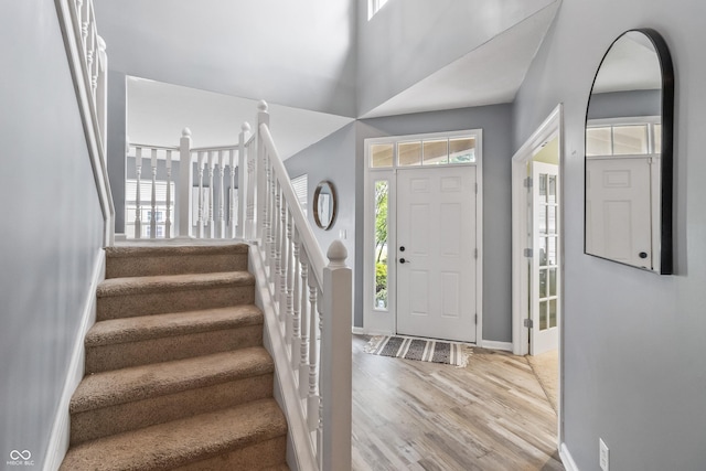 8663 N Commonview Dr, Mccordsville, IN 46055 - entrance foyer with stairway, wood finished floors, baseboards, and a high ceiling