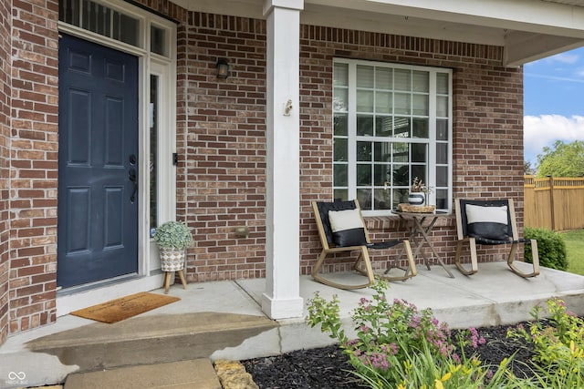 8663 N Commonview Dr, Mccordsville, IN 46055 - doorway to property featuring covered porch and brick siding