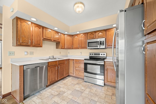 1105 Sarah Ct, Greenwood, IN 46142 - kitchen with stainless steel appliances, a sink, recessed lighting, light stone finish floors, and light countertops