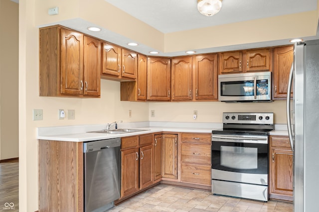 1105 Sarah Ct, Greenwood, IN 46142 - kitchen featuring stainless steel appliances, a sink, brown cabinets, and recessed lighting
