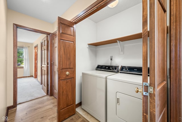 1105 Sarah Ct, Greenwood, IN 46142 - laundry room featuring independent washer and dryer, light wood-style floors, and baseboards