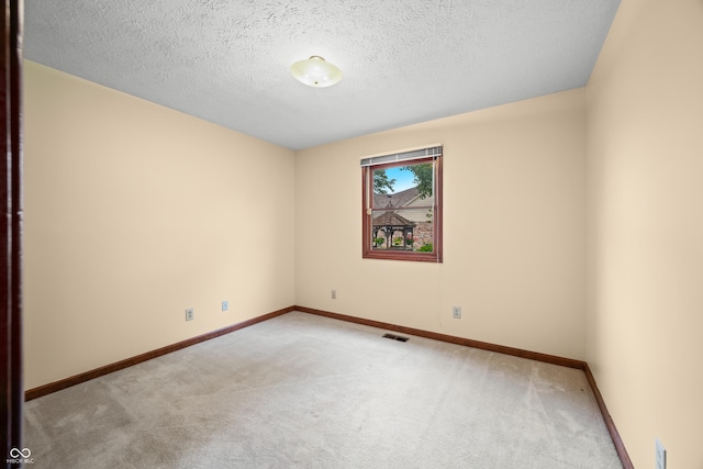 1105 Sarah Ct, Greenwood, IN 46142 - spare room featuring light carpet, baseboards, and a textured ceiling