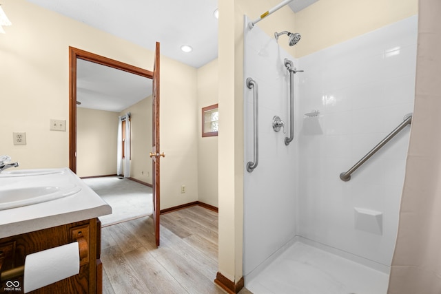 1105 Sarah Ct, Greenwood, IN 46142 - full bathroom featuring wood finished floors, tiled shower, vanity, baseboards, and recessed lighting