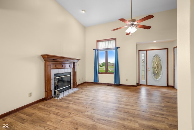 1105 Sarah Ct, Greenwood, IN 46142 - unfurnished living room with high vaulted ceiling, ceiling fan, a fireplace, wood finished floors, and baseboards