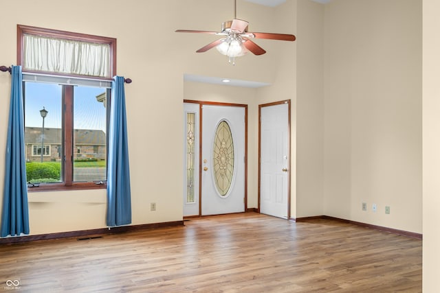 1105 Sarah Ct, Greenwood, IN 46142 - entrance foyer featuring wood finished floors, a ceiling fan, baseboards, and a towering ceiling