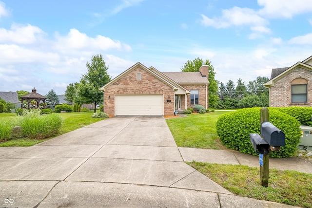 1105 Sarah Ct, Greenwood, IN 46142 - view of front of property with brick siding, an attached garage, concrete driveway, and a front yard