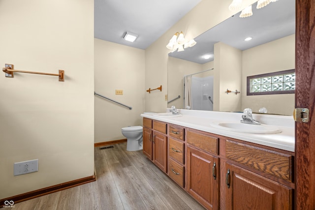 1105 Sarah Ct, Greenwood, IN 46142 - bathroom featuring double vanity, wood finished floors, baseboards, toilet, and a shower