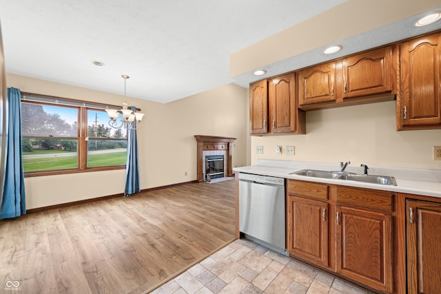 1105 Sarah Ct, Greenwood, IN 46142 - kitchen with stainless steel dishwasher, a sink, light countertops, a chandelier, and recessed lighting