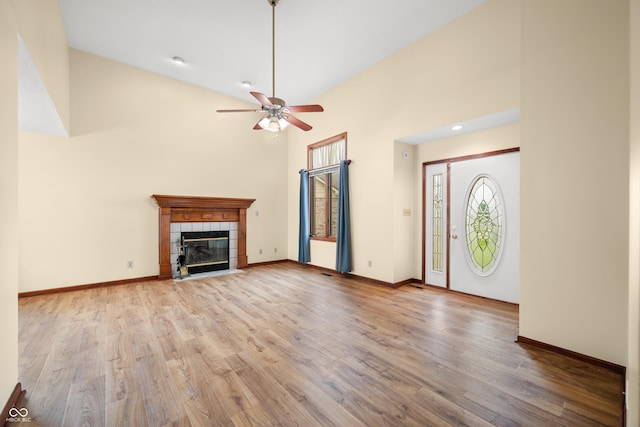 1105 Sarah Ct, Greenwood, IN 46142 - unfurnished living room with a ceiling fan, wood finished floors, plenty of natural light, a towering ceiling, and baseboards