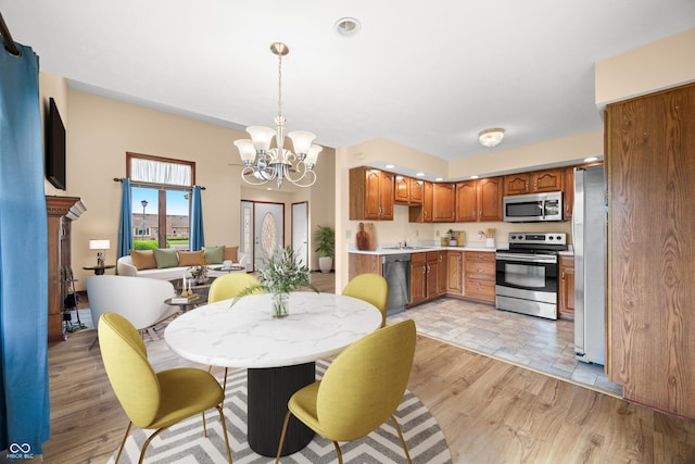 1105 Sarah Ct, Greenwood, IN 46142 - dining space with a chandelier and light wood-type flooring