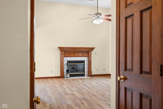 1105 Sarah Ct, Greenwood, IN 46142 - unfurnished living room featuring light wood-type flooring, a ceiling fan, a fireplace, and baseboards