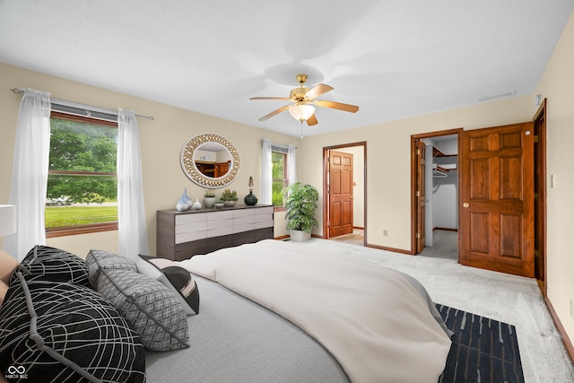 1105 Sarah Ct, Greenwood, IN 46142 - carpeted bedroom with a spacious closet, baseboards, and a ceiling fan
