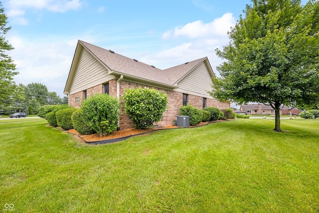 1105 Sarah Ct, Greenwood, IN 46142 - view of property exterior featuring brick siding, central AC unit, a yard, and roof with shingles
