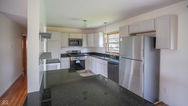 1460 W Mckay Rd, Shelbyville, IN 46176 - kitchen featuring stainless steel appliances, a sink, baseboards, and dark stone countertops