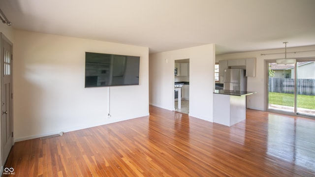 1460 W Mckay Rd, Shelbyville, IN 46176 - unfurnished living room featuring wood finished floors and baseboards