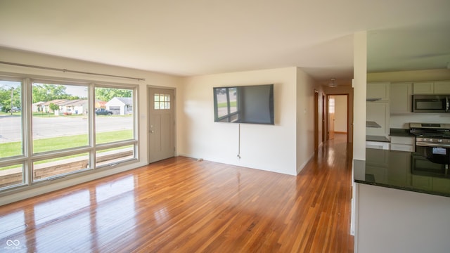 1460 W Mckay Rd, Shelbyville, IN 46176 - unfurnished living room featuring light wood finished floors and baseboards