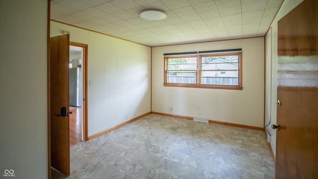 1460 W Mckay Rd, Shelbyville, IN 46176 - spare room with baseboards and wood walls