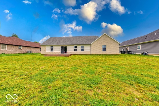 32 Downing Dr, Trafalgar, IN 46181 - rear view of property with a lawn and brick siding