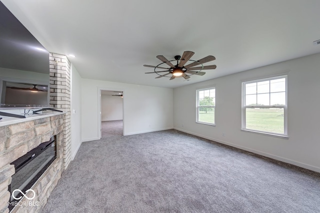 32 Downing Dr, Trafalgar, IN 46181 - unfurnished living room with a ceiling fan, carpet, baseboards, a large fireplace, and decorative columns