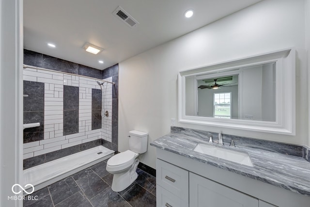 32 Downing Dr, Trafalgar, IN 46181 - full bathroom with toilet, vanity, tiled shower, baseboards, and ceiling fan