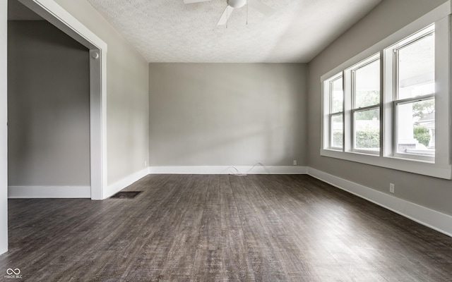 3652 N Kenwood Ave, Indianapolis, IN 46208 - empty room with a ceiling fan, dark wood-type flooring, a textured ceiling, and baseboards