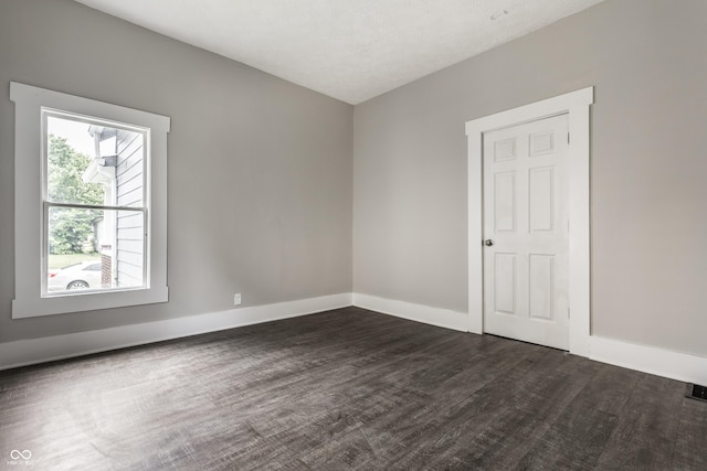 3652 N Kenwood Ave, Indianapolis, IN 46208 - spare room featuring baseboards and dark wood-style floors