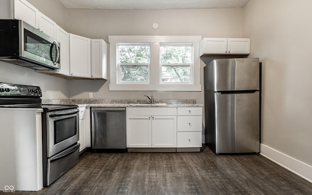 3652 N Kenwood Ave, Indianapolis, IN 46208 - kitchen featuring appliances with stainless steel finishes, a sink, white cabinetry, and dark wood-style flooring
