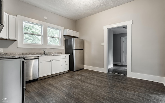3652 N Kenwood Ave, Indianapolis, IN 46208 - kitchen with stainless steel appliances, a sink, white cabinets, a textured ceiling, and light stone counters
