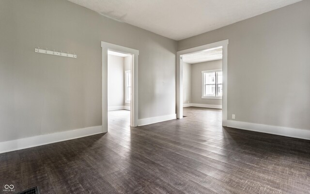 3652 N Kenwood Ave, Indianapolis, IN 46208 - spare room featuring dark wood finished floors and baseboards