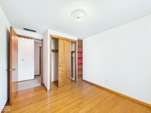 4733 E 100 S, Anderson, IN 46017 - unfurnished bedroom featuring light wood-style flooring, a closet, and baseboards