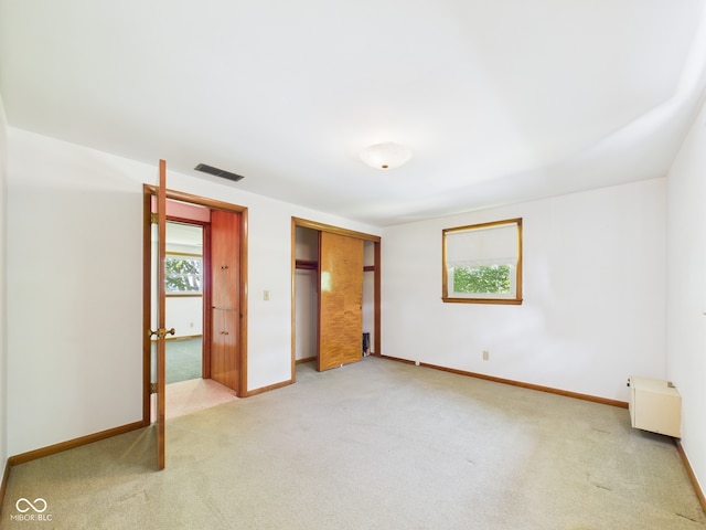 4733 E 100 S, Anderson, IN 46017 - unfurnished bedroom featuring light colored carpet, a closet, and baseboards