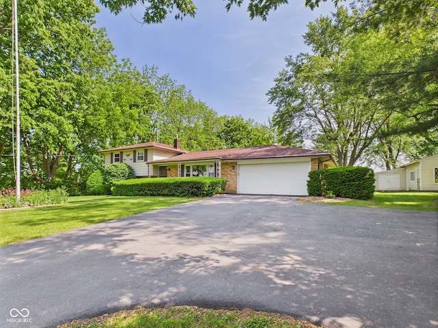 4733 E 100 S, Anderson, IN 46017 - split level home with driveway, a garage, a front yard, a chimney, and brick siding