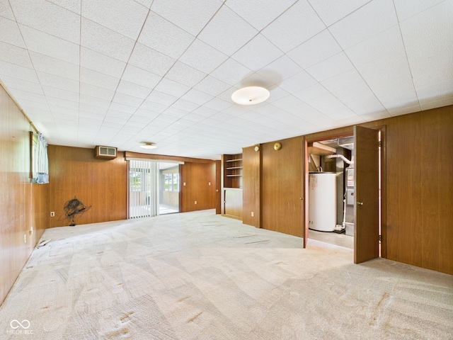 4733 E 100 S, Anderson, IN 46017 - carpeted spare room featuring gas water heater and wooden walls