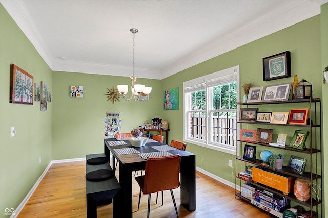 8030 Parcrest Ct, Indianapolis, IN 46259 - dining area featuring crown molding, wood finished floors, and a chandelier
