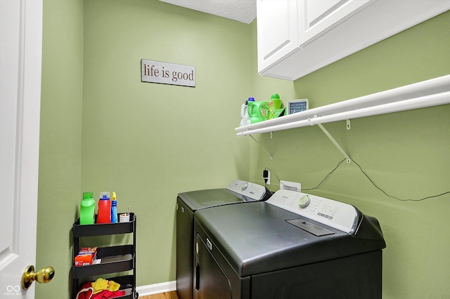 8030 Parcrest Ct, Indianapolis, IN 46259 - laundry room with washer and clothes dryer, cabinet space, and wood finished floors