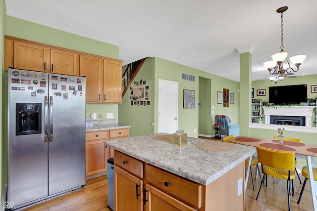 8030 Parcrest Ct, Indianapolis, IN 46259 - kitchen featuring stainless steel fridge, a chandelier, light wood-style flooring, light countertops, and open floor plan